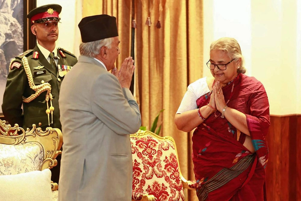 Nepalese President Ram Chandra Paudel (left) gestures after administering the oath of office to the country's newly appointed prime minister, Sushila Karki, during her swearing-in-ceremony at the President House in Kathmandu on Friday. Nepalese President Ram Chandra Paudel (left) gestures after administering the oath of office to the country's newly appointed prime minister, Sushila Karki, during her swearing-in-ceremony at the President House in Kathmandu on Friday.