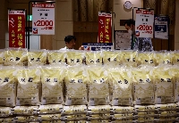 Government-stockpiled rice to be sold to help bring down high prices sits on display in a Tokyo grocery store on May 31. | REUTERS