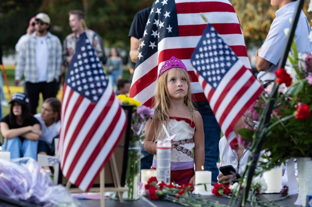 A young girl looks up at a photograph of Charlie Kirk during a candlelight vigil for the right-wing activist at a makeshift memorial at Memorial Park in Provo, Utah, on Friday. A young girl looks up at a photograph of Charlie Kirk during a candlelight vigil for the right-wing activist at a makeshift memorial at Memorial Park in Provo, Utah, on Friday.