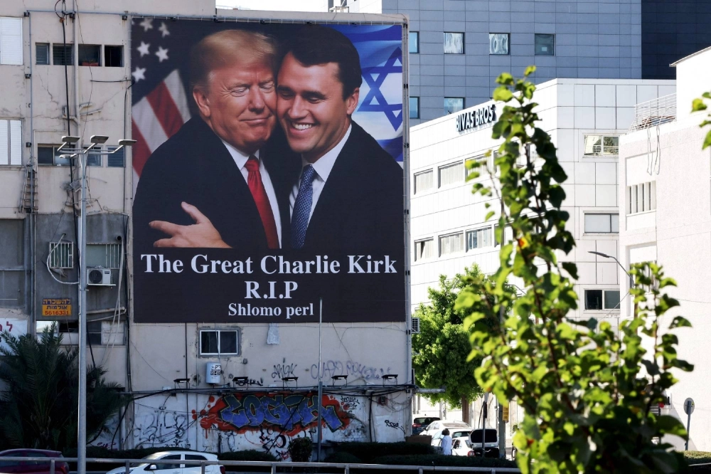 A billboard showing an image of U.S. President Donald Trump embracing prominent right-wing activist Charlie Kirk, who was shot dead by a single bullet while addressing a large crowd at Utah Valley University in the town of Orem on Wednesday, hangs on the side of a building in Tel Aviv on Saturday. A billboard showing an image of U.S. President Donald Trump embracing prominent right-wing activist Charlie Kirk, who was shot dead by a single bullet while addressing a large crowd at Utah Valley University in the town of Orem on Wednesday, hangs on the side of a building in Tel Aviv on Saturday.