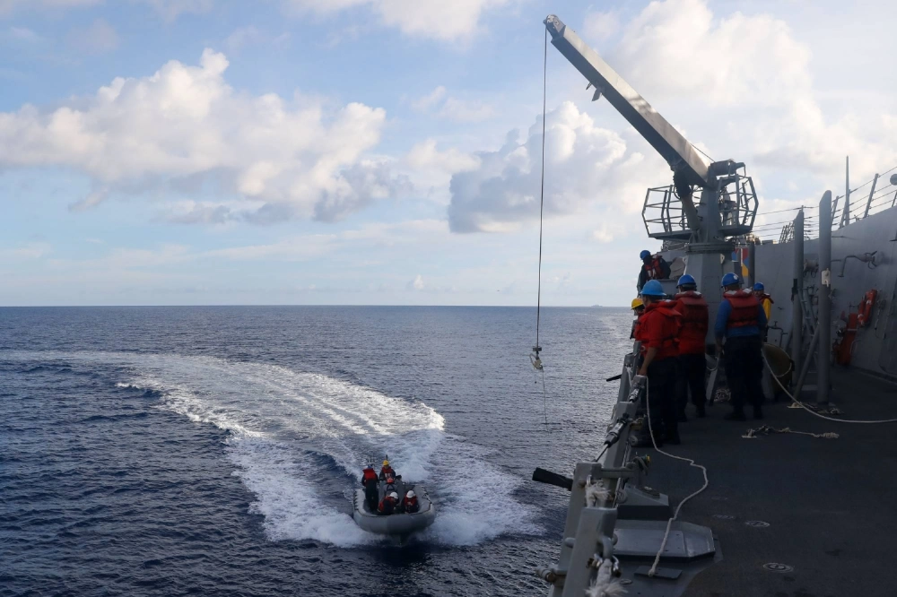 Sailors aboard the U.S. Navy's guided-missile destroyer USS John Finn conduct a small boat operation during a "Maritime Cooperative Activity" with the Maritime Self-Defense Force's Osumi tank-landing ship and the Philippine Navy's Jose Rizal frigate in the South China Sea on Saturday. Sailors aboard the U.S. Navy's guided-missile destroyer USS John Finn conduct a small boat operation during a "Maritime Cooperative Activity" with the Maritime Self-Defense Force's Osumi tank-landing ship and the Philippine Navy's Jose Rizal frigate in the South China Sea on Saturday.
