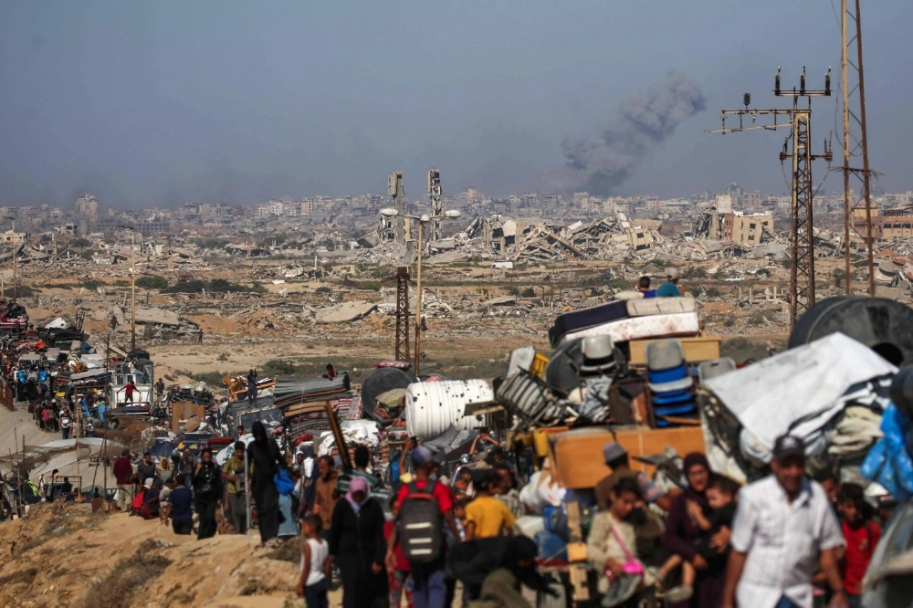 Displaced Palestinians move with their belongings southwards as smoke billows from Israeli strikes in Gaza City on Sunday. Displaced Palestinians move with their belongings southwards as smoke billows from Israeli strikes in Gaza City on Sunday.