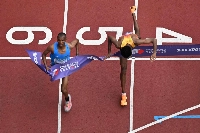 Germany's Amanal Petros (R) falls as he crosses the finish line behind Tanzania's athlete Alphonce Felix Simbu (L) in the men's marathon final during the World Athletics Championships in Tokyo on Monday. | AFP-JIJI