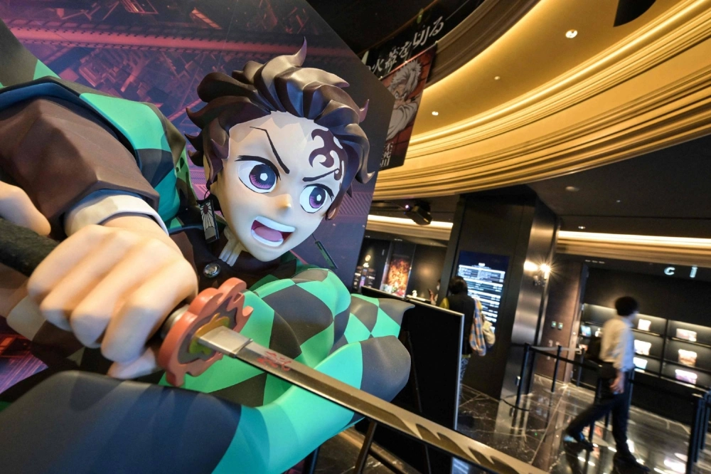 A statue of young swordsman Tanjiro Kamado, the title character in the "Demon Slayer" anime franchise, is displayed at a cinema in Tokyo's Ikebukuro district on Sept. 9. A statue of young swordsman Tanjiro Kamado, the title character in the "Demon Slayer" anime franchise, is displayed at a cinema in Tokyo's Ikebukuro district on Sept. 9.