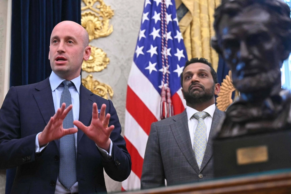 FBI Director Kash Patel (right) listens to senior White House adviser Stephen Miller speak in the Oval Office of the White House in Washington on Monday. FBI Director Kash Patel (right) listens to senior White House adviser Stephen Miller speak in the Oval Office of the White House in Washington on Monday.