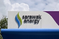 The Sarawak Energy logo at an electric vehicle charging station in Kuching on the island of Borneo. Malaysia's verdant, river-crossed state of Sarawak is charging ahead with plans to become a regional "green battery," but its renewable energy dreams could come at serious environmental cost, experts warn. | AFP-JIJI