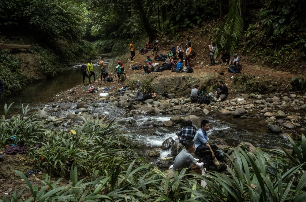 Chinese migrants intent on reaching the United States walking in the jungle of Panama’s Darien Gap on March 3, 2023.  Chinese migrants intent on reaching the United States walking in the jungle of Panama’s Darien Gap on March 3, 2023.