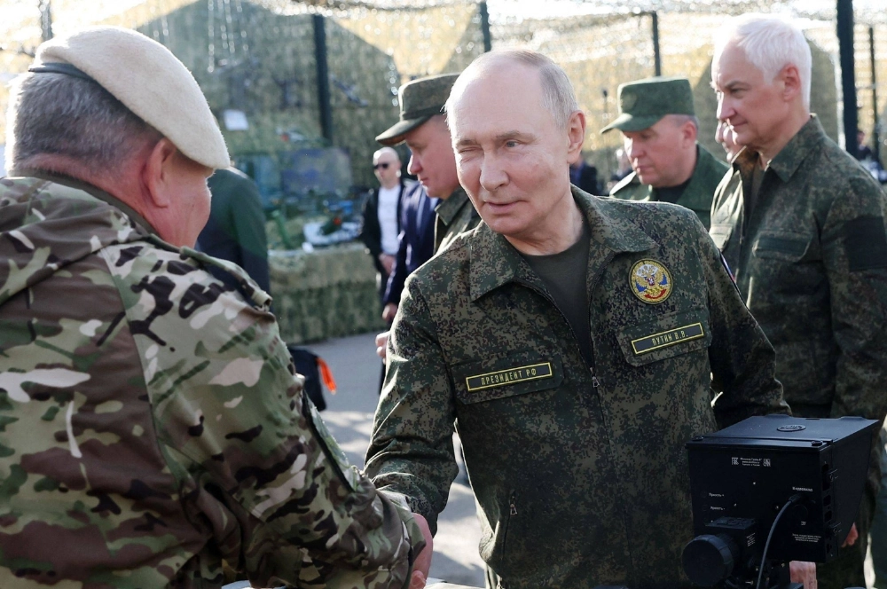 Russian President Vladimir Putin tours an exhibition of military equipment while inspecting the joint Russian-Belarusian military drills at a training ground in Russia's Nizhny Novogorod region on Tuesday. Russian President Vladimir Putin tours an exhibition of military equipment while inspecting the joint Russian-Belarusian military drills at a training ground in Russia's Nizhny Novogorod region on Tuesday.