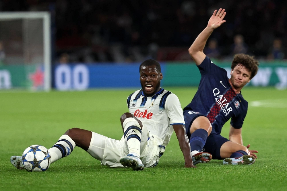 Atalanta midfielder Yunus Musah (left) and Paris Saint-Germain midfielder Joao Neves fight for the ball during their Champions League match on Wednesday in Paris.  Atalanta midfielder Yunus Musah (left) and Paris Saint-Germain midfielder Joao Neves fight for the ball during their Champions League match on Wednesday in Paris.