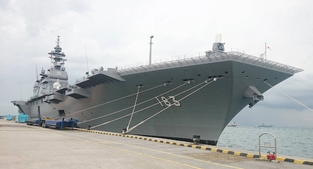 The Izumo destroyer docks at a port in Singapore after completing a mission to escort a U.S. vessel under Japan's security laws, in May 2017. The Izumo destroyer docks at a port in Singapore after completing a mission to escort a U.S. vessel under Japan's security laws, in May 2017.