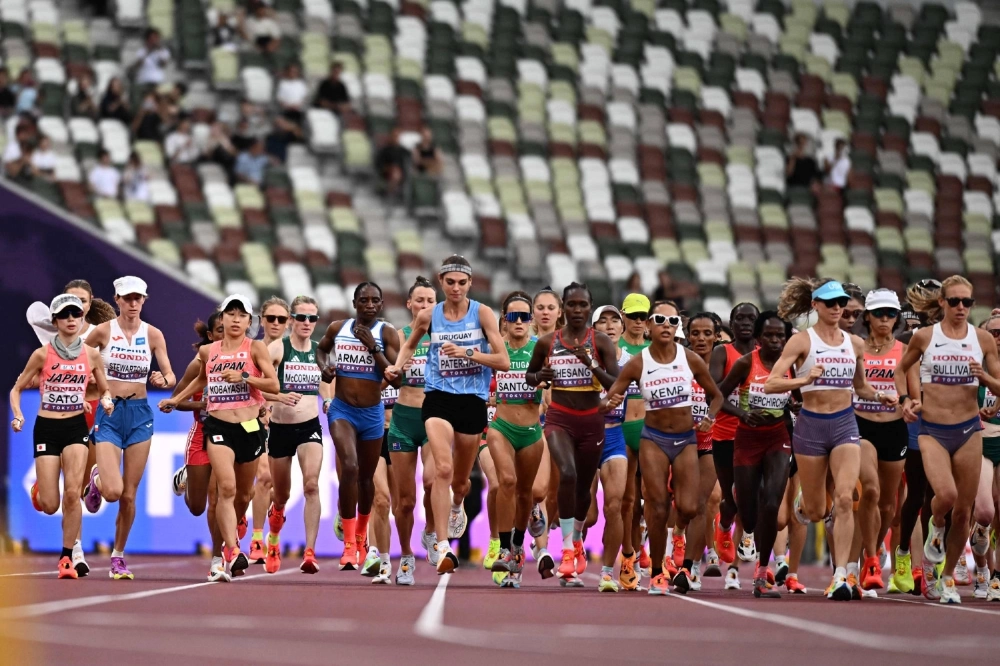 Runners compete in the women's marathon at the World Athletics Championships in Tokyo on Sunday. Runners compete in the women's marathon at the World Athletics Championships in Tokyo on Sunday.