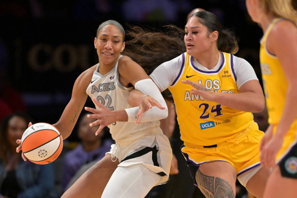 Aces center A'ja Wilson (left) is fouled by Sparks forward Alissa Pili in Los Angeles on Sept. 11.