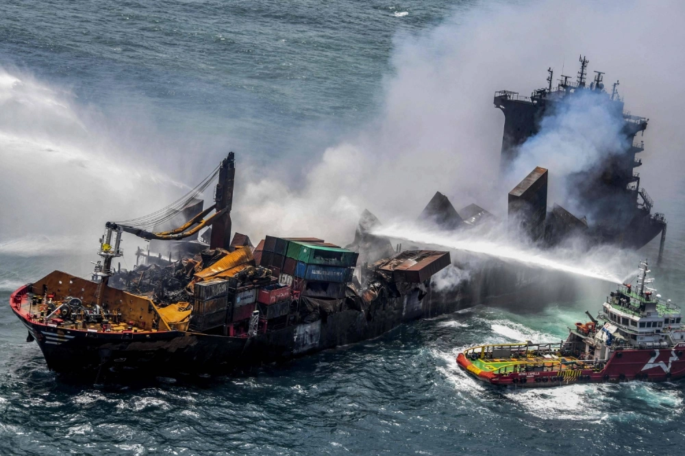Smoke billows from the Singapore-registered container ship MV X-Press Pearl, which had been burning for eleven consecutive days, while vessels try to extinguish the fire in the sea off Sri Lanka's Colombo Harbor on May 30, 2021. Smoke billows from the Singapore-registered container ship MV X-Press Pearl, which had been burning for eleven consecutive days, while vessels try to extinguish the fire in the sea off Sri Lanka's Colombo Harbor on May 30, 2021.