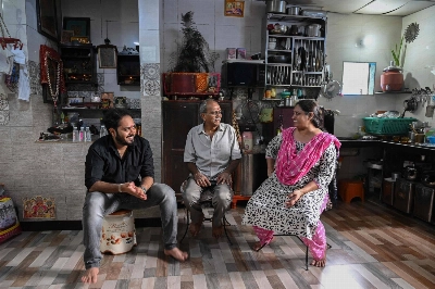 Bipinkumar Padaya (center) sits with his wife and son at home in Dharavi, a slum settlement in Mumbai. Bipinkumar Padaya (center) sits with his wife and son at home in Dharavi, a slum settlement in Mumbai.