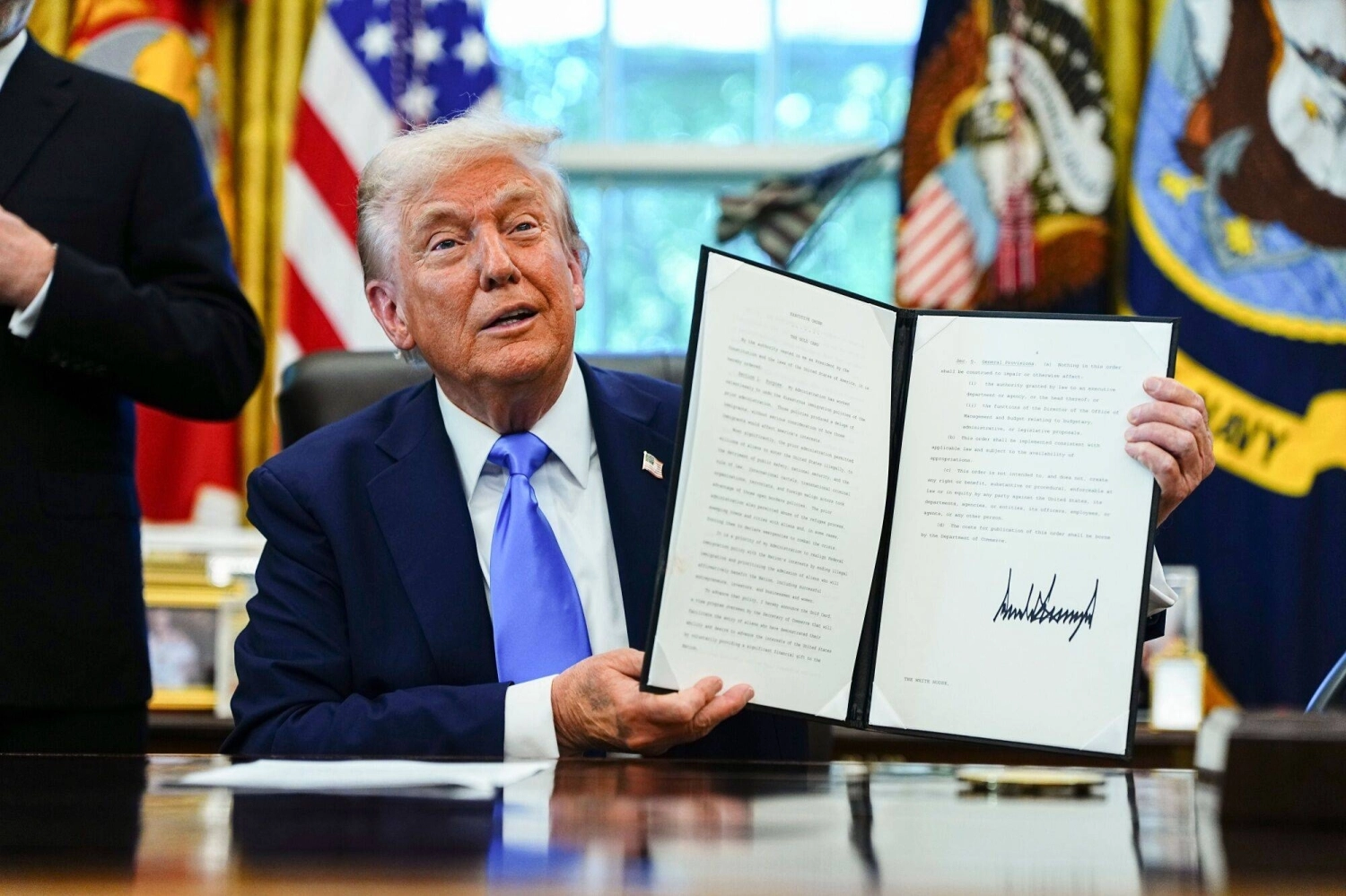 U.S. President Donald Trump holds a signed executive order authorizing the Trump Gold Card, an investor visa, in the Oval Office of the White House in Washington on Sept. 19. U.S. President Donald Trump holds a signed executive order authorizing the Trump Gold Card, an investor visa, in the Oval Office of the White House in Washington on Sept. 19.