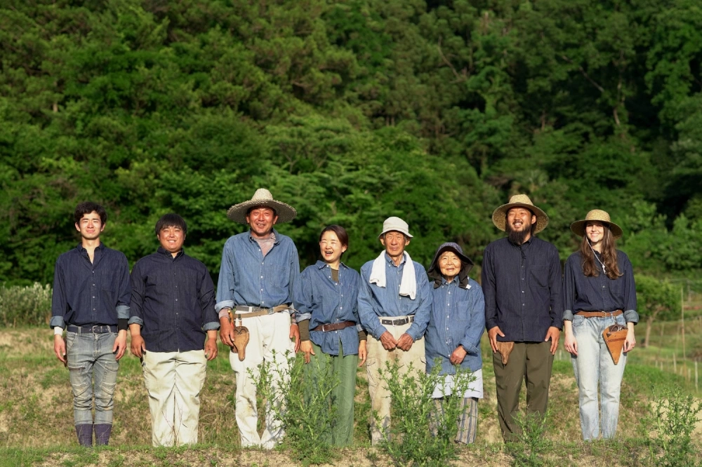 The team at Ryokukou Garden consists primarily of a single family, including Toshiki Tanisaki (second from right), who led the company's efforts at the Osaka Expo, Chikako Tanisaki (fifth from right), who performs daily maintanence at the expo, and Takeshi Tanisaki (fourth from right), who added a nursery to the family farm more than 50 years ago. The team at Ryokukou Garden consists primarily of a single family, including Toshiki Tanisaki (second from right), who led the company's efforts at the Osaka Expo, Chikako Tanisaki (fifth from right), who performs daily maintanence at the expo, and Takeshi Tanisaki (fourth from right), who added a nursery to the family farm more than 50 years ago.