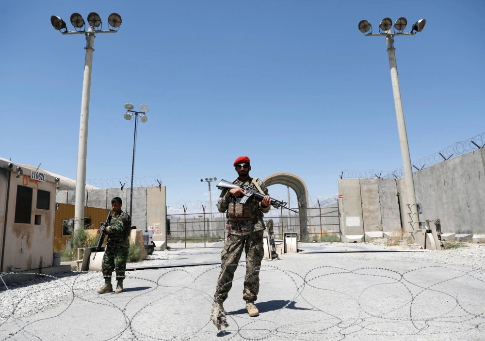 Afghan soldiers stand guard at the gate of Bagram Air Base, Parwan province, Afghanistan, on July 2, 2021, the day the last American troops vacated the facility. Afghan soldiers stand guard at the gate of Bagram Air Base, Parwan province, Afghanistan, on July 2, 2021, the day the last American troops vacated the facility.