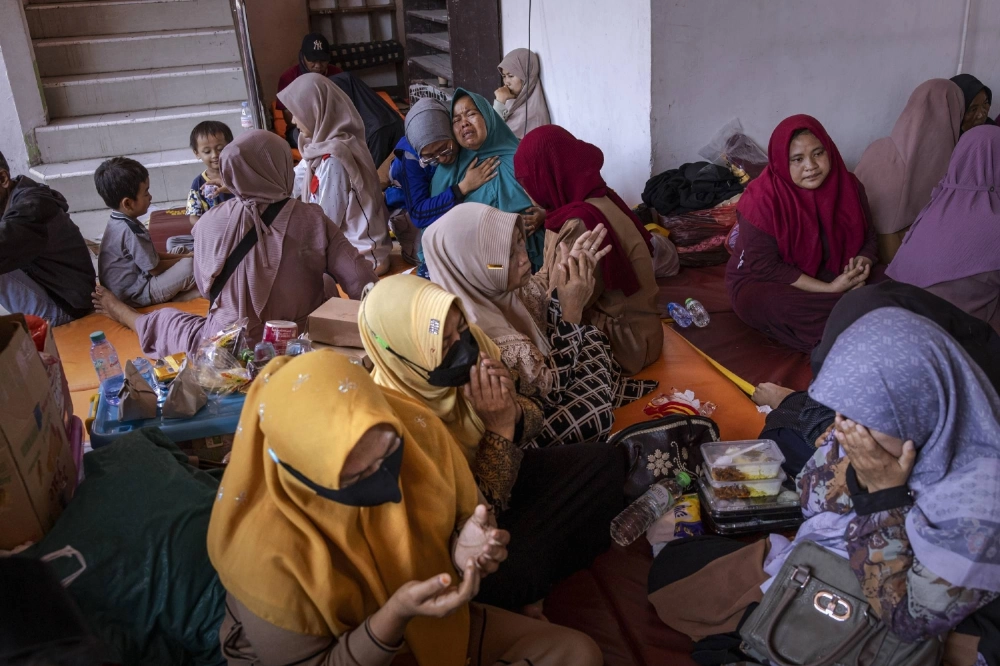 Relatives of missing students mourn on Thursday as they wait for rescuers to search for survivors at the Al Khoziny Islamic boarding school in Sidoarjo, East Java province, Indonesia, which collapsed on Monday. Relatives of missing students mourn on Thursday as they wait for rescuers to search for survivors at the Al Khoziny Islamic boarding school in Sidoarjo, East Java province, Indonesia, which collapsed on Monday.