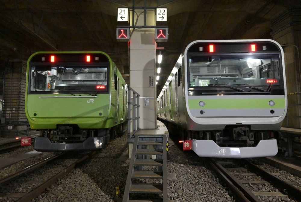 Trains decorated to resemble the 103 (left) and 205 series of trains that formerly ran on the Yamanote Line, in Tokyo on Saturday.  Trains decorated to resemble the 103 (left) and 205 series of trains that formerly ran on the Yamanote Line, in Tokyo on Saturday.