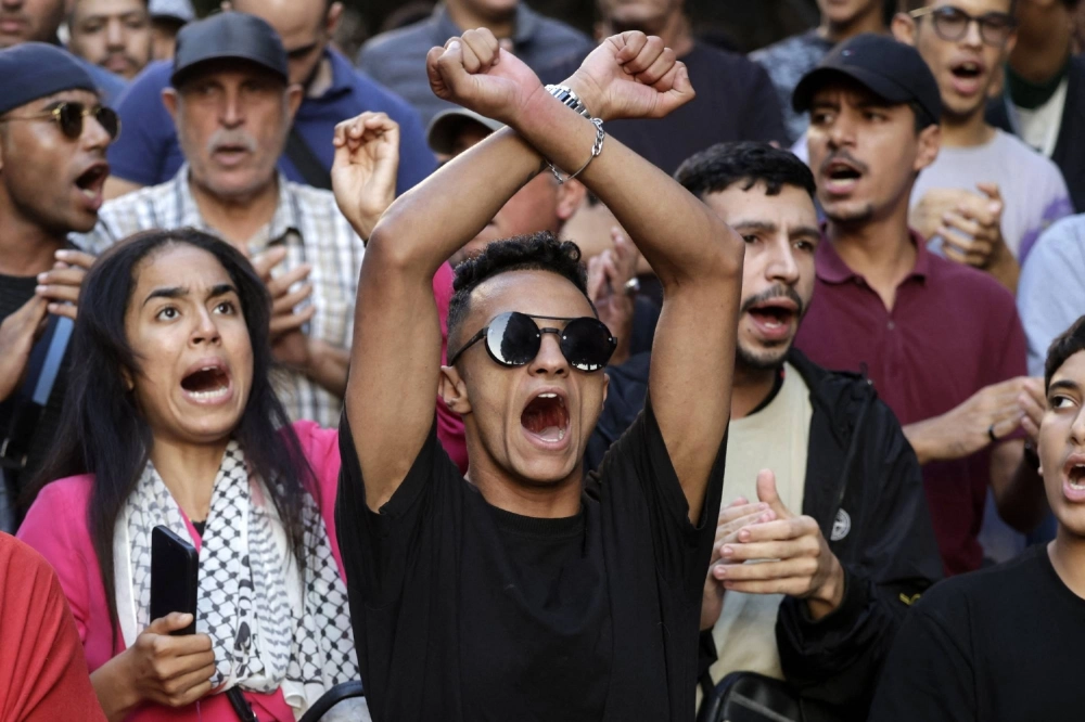 Moroccan youth from a collective calling itself GenZ 212 chant slogans as they rally for a seventh straight day to demand reforms to public health care and education. Moroccan youth from a collective calling itself GenZ 212 chant slogans as they rally for a seventh straight day to demand reforms to public health care and education.