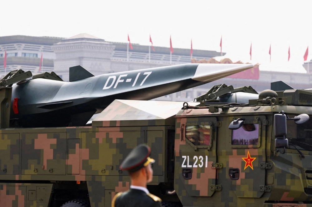 A member of the Chinese People's Liberation Army stands as a DF-17 hypersonic missile is displayed during a military parade to mark the 80th anniversary of the end of World War II, in Beijing on Sept. 3. A member of the Chinese People's Liberation Army stands as a DF-17 hypersonic missile is displayed during a military parade to mark the 80th anniversary of the end of World War II, in Beijing on Sept. 3.