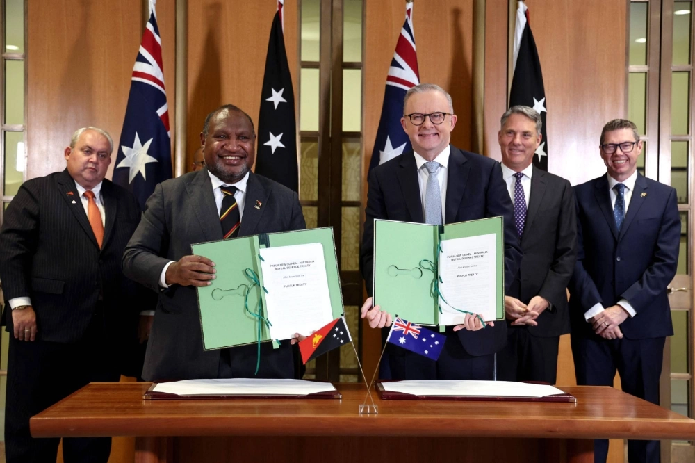Australian Prime Minister Anthony Albanese (center right) and Papua New Guinea leader James Marape pose with officials after the signing of the Pukpuk Treaty at Parliament House in Canberra on Monday. Australian Prime Minister Anthony Albanese (center right) and Papua New Guinea leader James Marape pose with officials after the signing of the Pukpuk Treaty at Parliament House in Canberra on Monday.