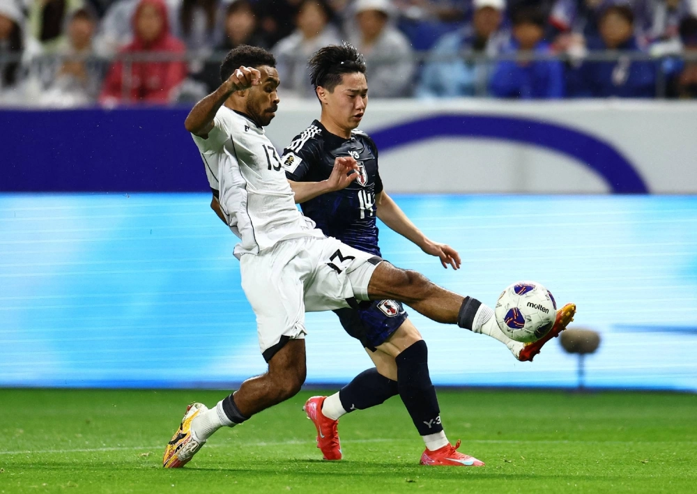 Indonesia's Yance Sayuri (left) and Japan's Shunsuke Mito vie for the ball during a World Cup qualifier in Suita, Osaka Prefecture, on June 10. Indonesia's Yance Sayuri (left) and Japan's Shunsuke Mito vie for the ball during a World Cup qualifier in Suita, Osaka Prefecture, on June 10.