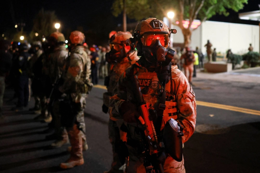Law enforcement officers stand guard outside the U.S. Immigration and Customs Enforcement (ICE) headquarters, after U.S. District Judge Karin Immergut on Sunday temporarily blocked U.S. President Donald Trump's administration from sending any National Guard troops to police Portland, in south Portland, Oregon, on Sunday.  Law enforcement officers stand guard outside the U.S. Immigration and Customs Enforcement (ICE) headquarters, after U.S. District Judge Karin Immergut on Sunday temporarily blocked U.S. President Donald Trump's administration from sending any National Guard troops to police Portland, in south Portland, Oregon, on Sunday.
