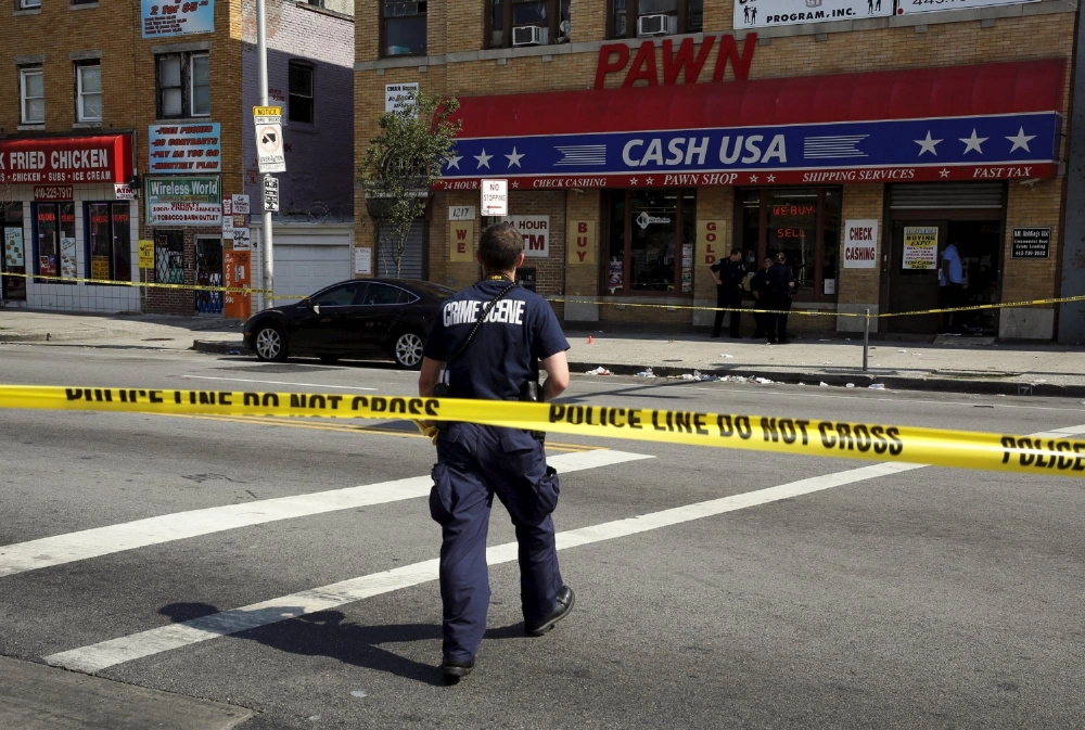A crime scene technician prepares to document evidence at the site of a shooting in West Baltimore in May 2015. U.S. cities are seeing murder rates fall sharply from post-2020 highs thanks to local violence-reduction efforts and pandemic-era investments. A crime scene technician prepares to document evidence at the site of a shooting in West Baltimore in May 2015. U.S. cities are seeing murder rates fall sharply from post-2020 highs thanks to local violence-reduction efforts and pandemic-era investments.