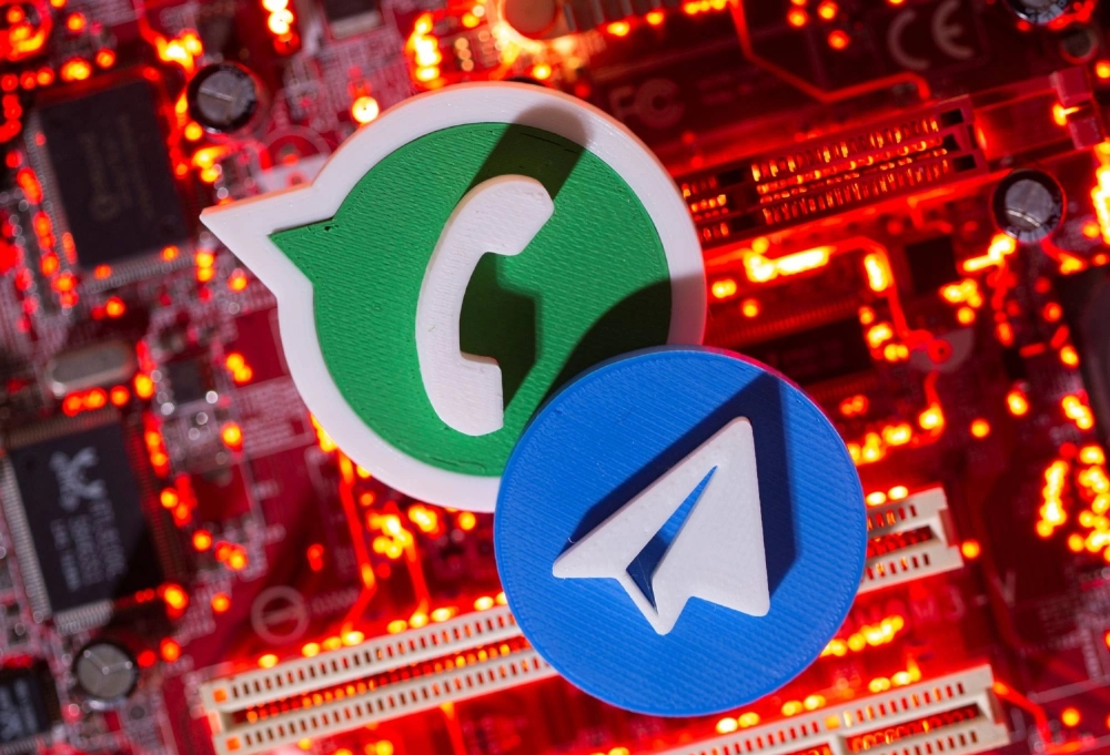 3D printed Telegram and WhatsApp logos are placed on a computer motherboard in this illustration taken January 21, 2021.  3D printed Telegram and WhatsApp logos are placed on a computer motherboard in this illustration taken January 21, 2021.