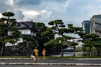 Tourists in front of the Imperial Palace in Tokyo on Sept. 10. Increased spending by foreign visitors and brisk home sales are behind an improvement in economy-watcher sentiment, a survey has shown. | AFP-JIJI