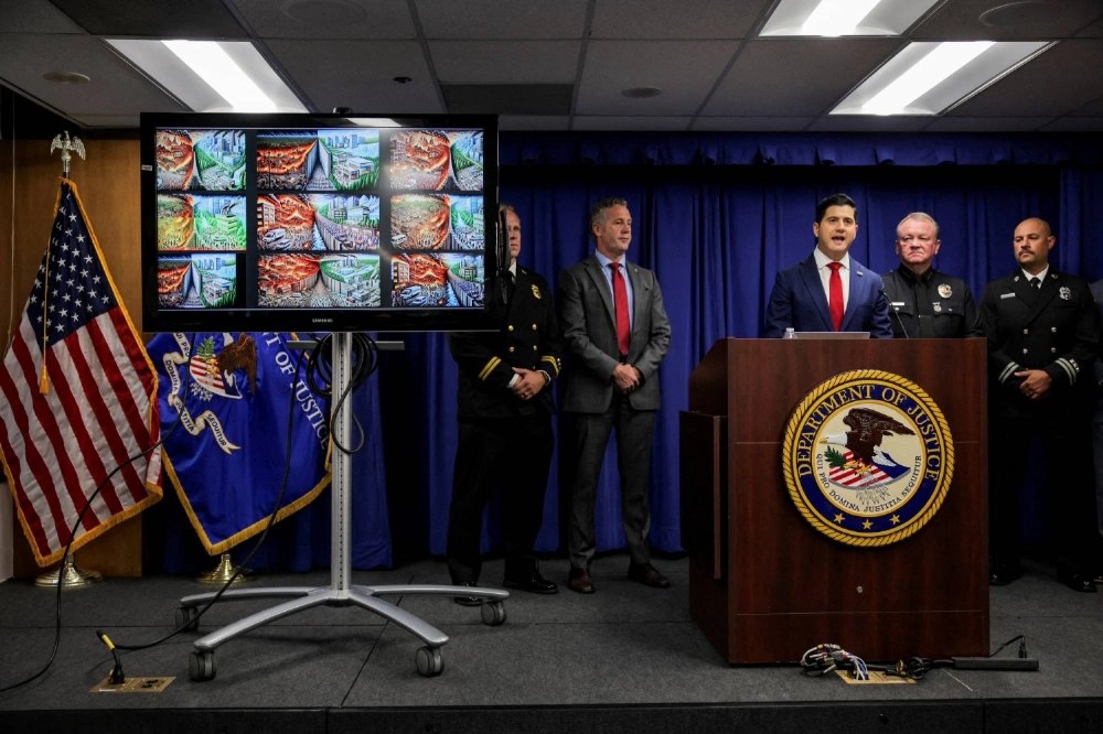 A monitor shows AI-generated images found on the computer of a man who has been arrested on charges he intentionally ignited the Pacific Palisades Fire, during a press conference with Acting United States Attorney for the Central District of California Bill Essayli and Special Agent in Charge of the Bureau of Alcohol, Tobacco, Firearms and Explosives of the Los Angeles Field Division Kenny Cooper, in Los Angeles on Wednesday. A monitor shows AI-generated images found on the computer of a man who has been arrested on charges he intentionally ignited the Pacific Palisades Fire, during a press conference with Acting United States Attorney for the Central District of California Bill Essayli and Special Agent in Charge of the Bureau of Alcohol, Tobacco, Firearms and Explosives of the Los Angeles Field Division Kenny Cooper, in Los Angeles on Wednesday.
