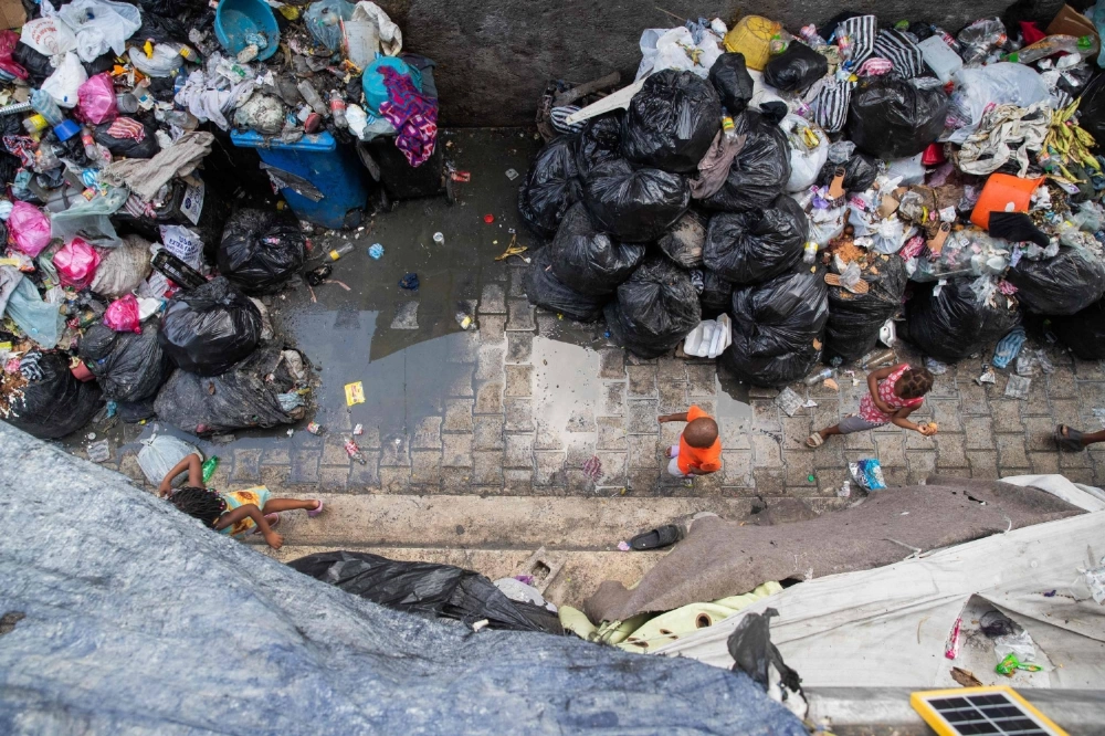 Haitian children walk past piles of garbage at the School Argentine Bellegarde, converted into a shelter for displaced people, in downtown Port-au-Prince on Oct. 3. More than 16,000 people have been killed in armed violence in Haiti since the start of 2022, the United Nations said on October 3, warning that "the worst may be yet to come." Haitian children walk past piles of garbage at the School Argentine Bellegarde, converted into a shelter for displaced people, in downtown Port-au-Prince on Oct. 3. More than 16,000 people have been killed in armed violence in Haiti since the start of 2022, the United Nations said on October 3, warning that "the worst may be yet to come."