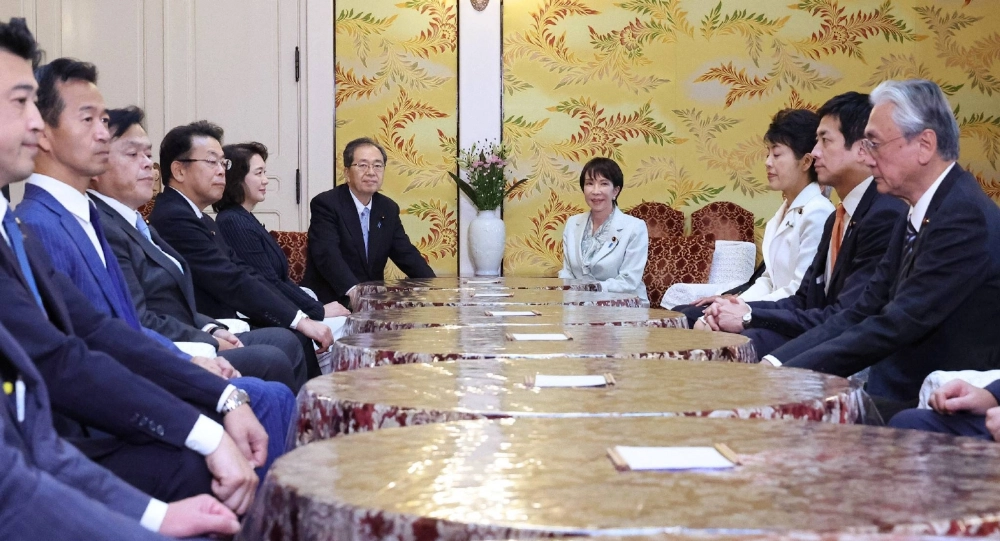 Komeito head Tetsuo Saito and the party's executives (left) meet with the LDP's Sanae Takaichi and counterparts in Tokyo on Tuesday. Komeito head Tetsuo Saito and the party's executives (left) meet with the LDP's Sanae Takaichi and counterparts in Tokyo on Tuesday.