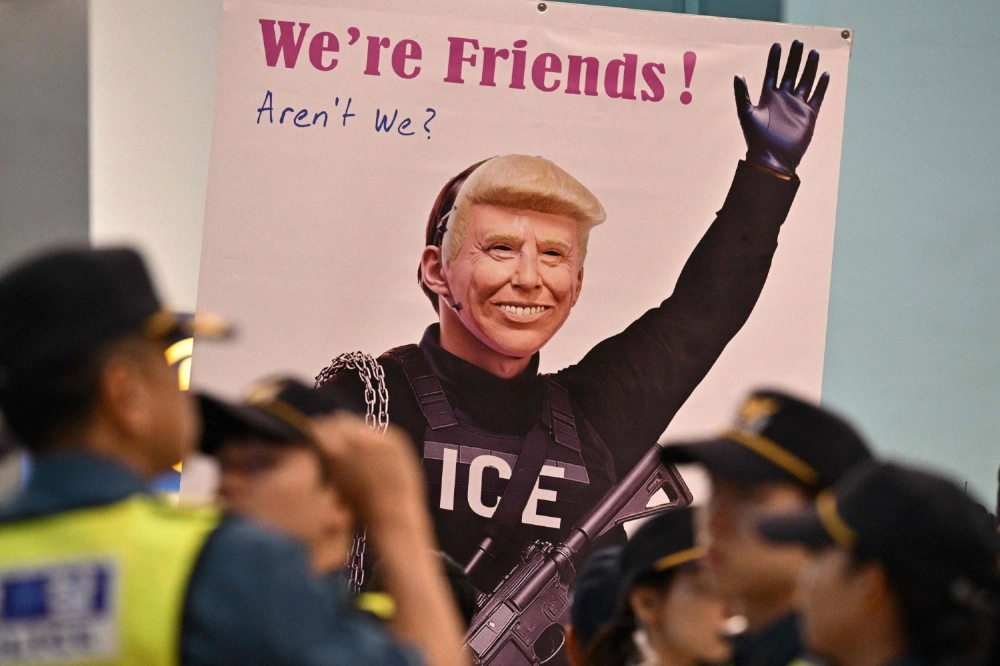 A protester displays a poster featuring U.S. President Donald Trump at Incheon Airport on Sept. 12 after South Korean workers detained in a U.S. immigration raid at a Hyundai-LG plant in Georgia returned home. A protester displays a poster featuring U.S. President Donald Trump at Incheon Airport on Sept. 12 after South Korean workers detained in a U.S. immigration raid at a Hyundai-LG plant in Georgia returned home.