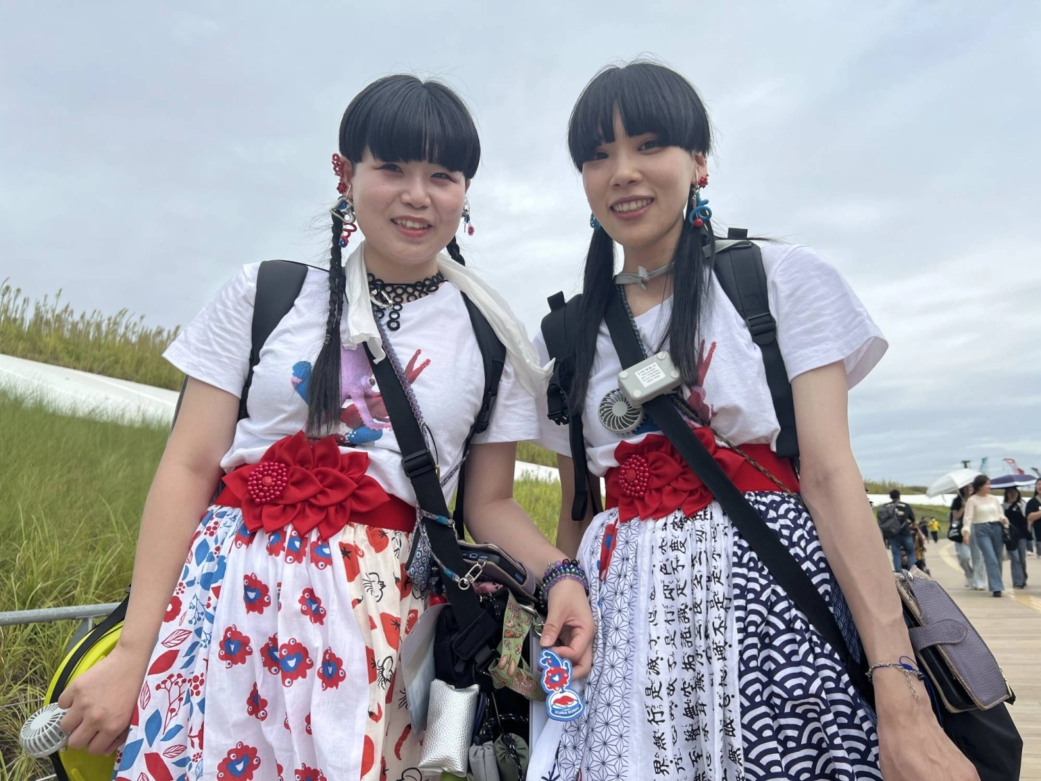 Hana Hisada (left) and Mao Tanaka were among the many visitors to incorporate Osaka Expo mascot Myaku-Myaku into their attire. Hana Hisada (left) and Mao Tanaka were among the many visitors to incorporate Osaka Expo mascot Myaku-Myaku into their attire.
