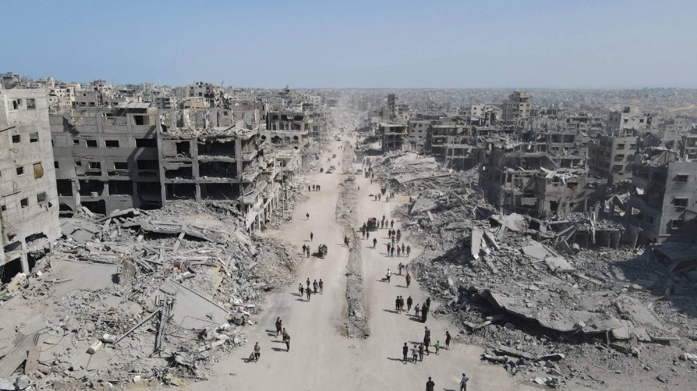 People walk amid the destruction in Gaza City, in the northern Gaza Strip, on Saturday, a day after an Israel-Hamas ceasefire took effect. People walk amid the destruction in Gaza City, in the northern Gaza Strip, on Saturday, a day after an Israel-Hamas ceasefire took effect.