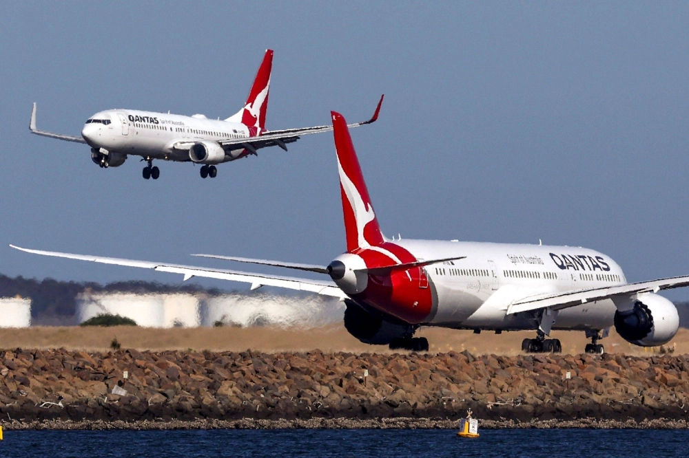 A Qantas Boeing 737-800 plane prepares to land next to a Qantas Boeing 787 Dreamliner aircraft preparing to take off at Sydney International Airport in September last year. The Australian airline said Sunday that data from 5.7 million customers stolen in a major cyberattack in July had been leaked online. A Qantas Boeing 737-800 plane prepares to land next to a Qantas Boeing 787 Dreamliner aircraft preparing to take off at Sydney International Airport in September last year. The Australian airline said Sunday that data from 5.7 million customers stolen in a major cyberattack in July had been leaked online.
