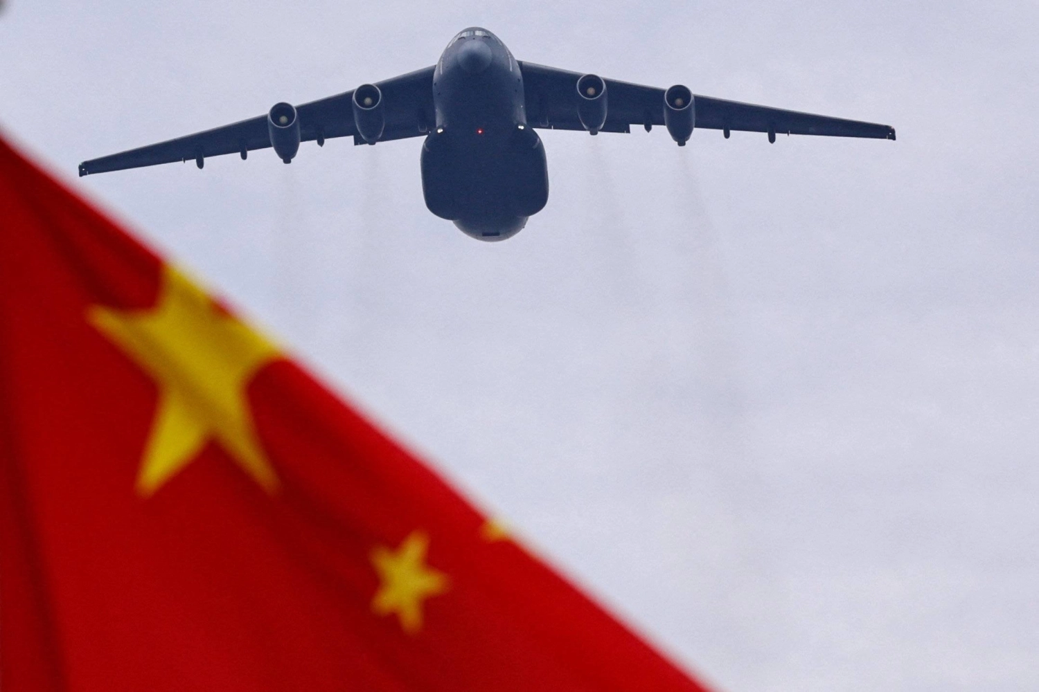 A Xian Y-20 transport aircraft, capable of dropping paratroopers, flies past a Chinese national flag during a flyover rehearsal ahead of a military parade to mark the 80th anniversary of the end of World War II, in Beijing on Aug. 24. A Xian Y-20 transport aircraft, capable of dropping paratroopers, flies past a Chinese national flag during a flyover rehearsal ahead of a military parade to mark the 80th anniversary of the end of World War II, in Beijing on Aug. 24.