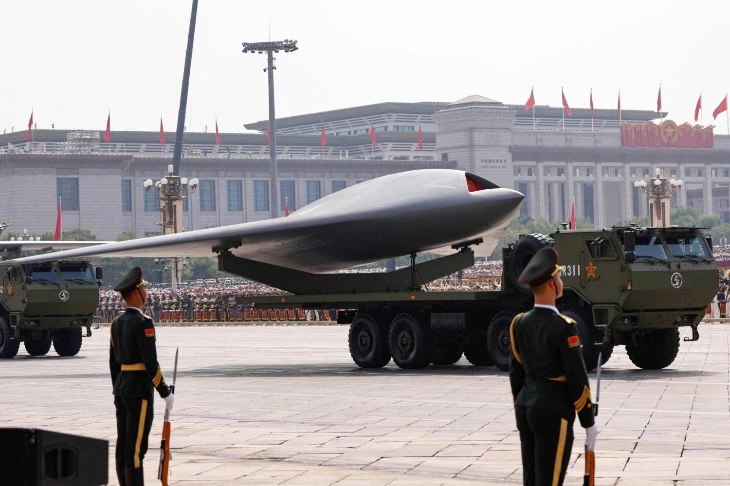 People's Liberation Army members stand as a drone is displayed during a military parade to mark the 80th anniversary of the end of World War II, in Beijing on Sept. 3. People's Liberation Army members stand as a drone is displayed during a military parade to mark the 80th anniversary of the end of World War II, in Beijing on Sept. 3.