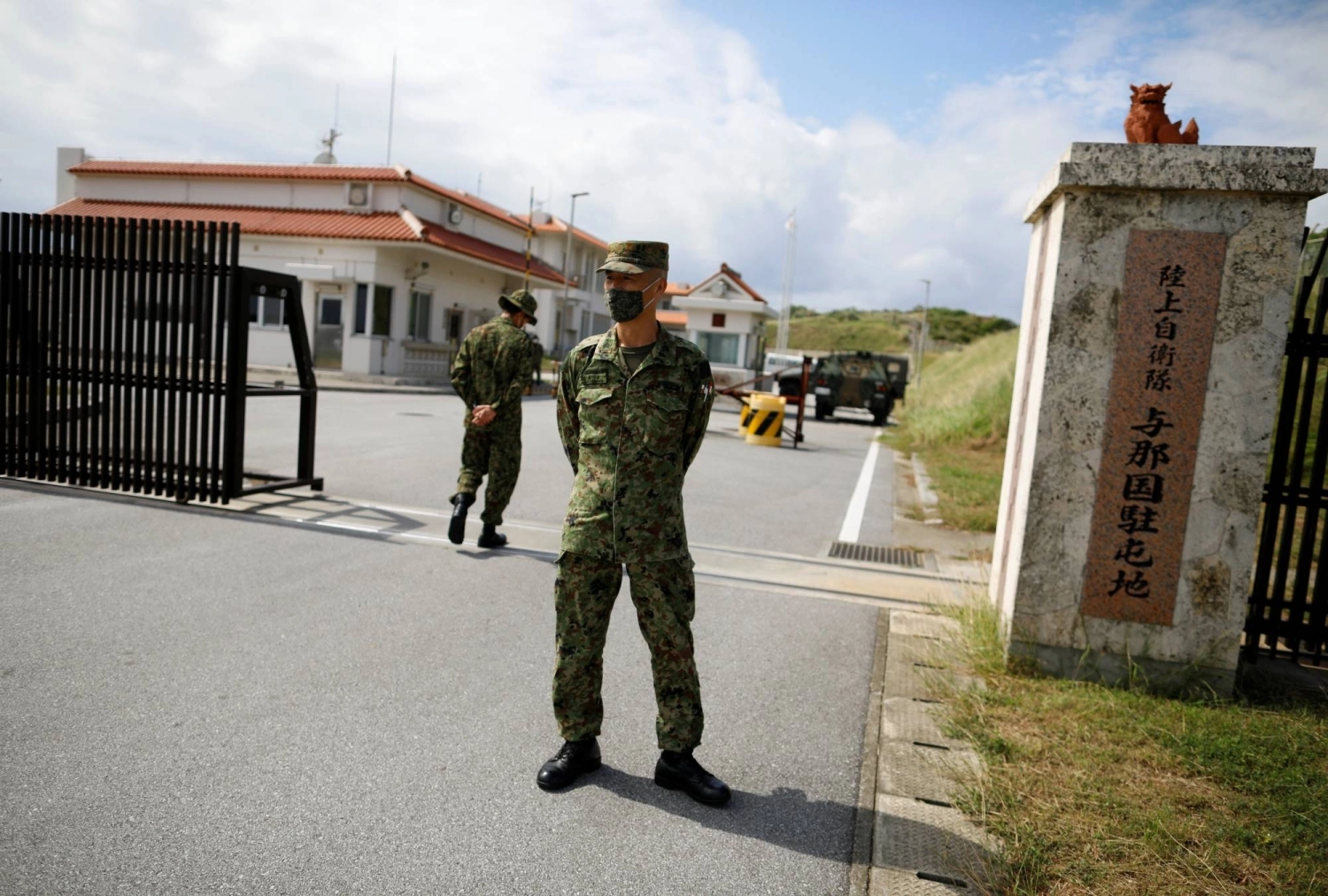 Ground Self-Defense Force troops stand at the entrance gate of the Yonaguni base on the country's westernmost inhabited island of Yonaguni, Okinawa Prefecture — just 110 kilometers from Taiwan — in October 2021. Ground Self-Defense Force troops stand at the entrance gate of the Yonaguni base on the country's westernmost inhabited island of Yonaguni, Okinawa Prefecture — just 110 kilometers from Taiwan — in October 2021.