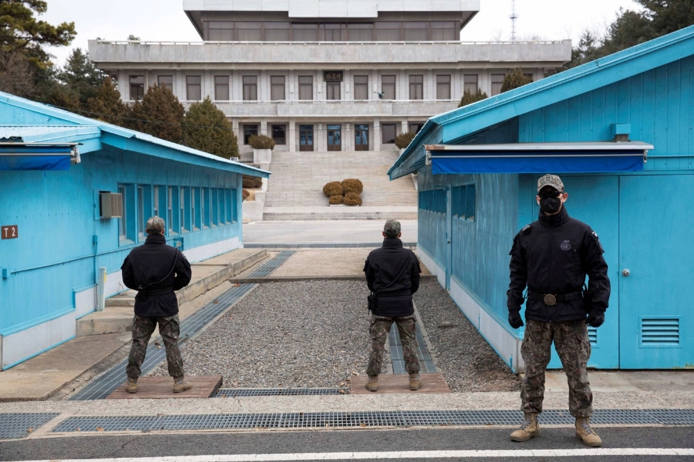 South Korean soldiers stand guard at the Joint Security Area in the DMZ border village of Panmunjom in March 2023.
 South Korean soldiers stand guard at the Joint Security Area in the DMZ border village of Panmunjom in March 2023.