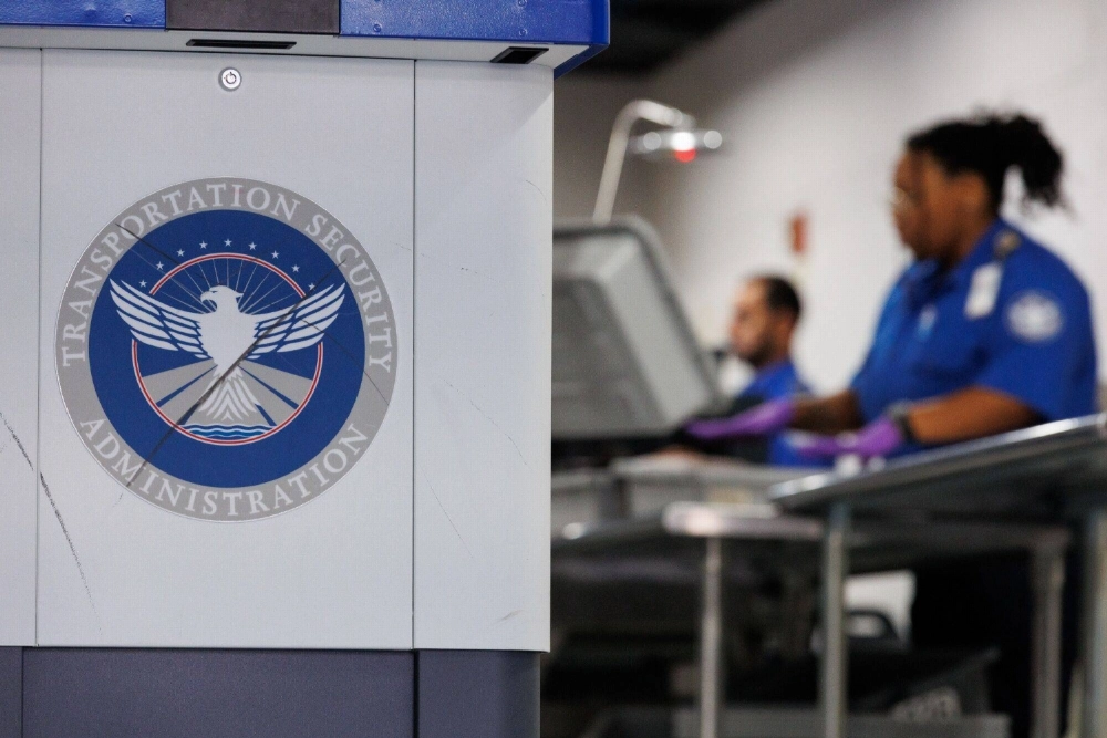 Transportation Security Administration agents at a security checkpoint at Dallas-Fort Worth International Airport in Dallas, Texas, on Monday Transportation Security Administration agents at a security checkpoint at Dallas-Fort Worth International Airport in Dallas, Texas, on Monday