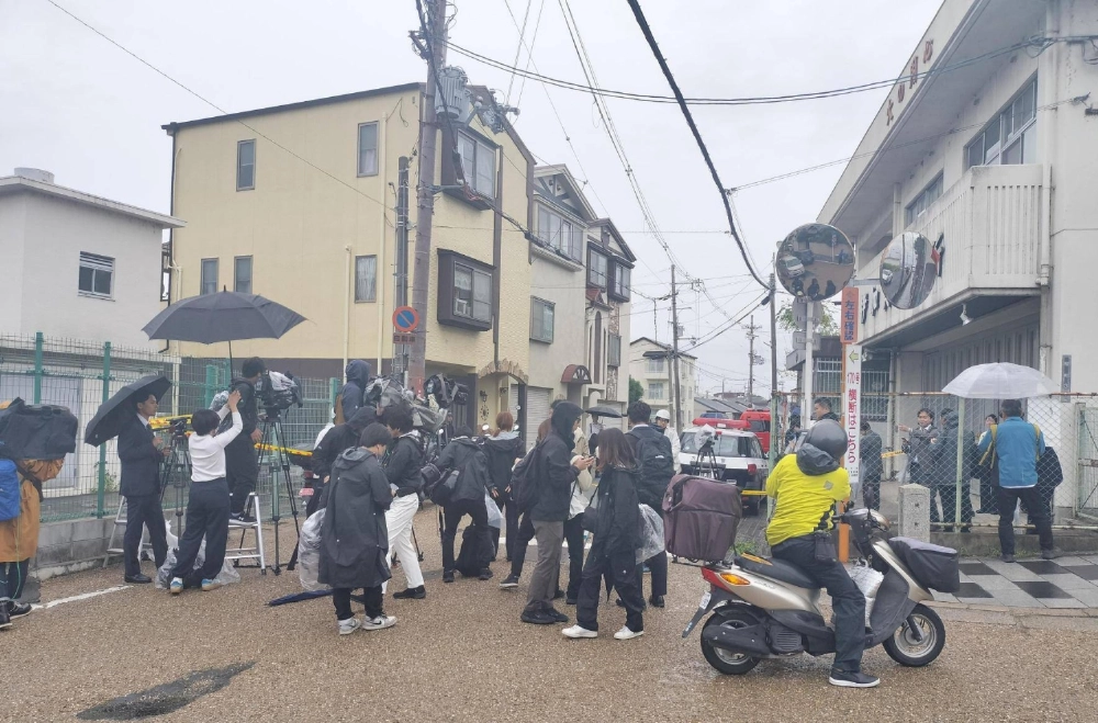 Media gathered near the scene where a man barricaded himself with a knife on Wednesday in the city of Hirakata, Osaka Prefecture Media gathered near the scene where a man barricaded himself with a knife on Wednesday in the city of Hirakata, Osaka Prefecture