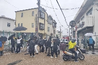 Media gathered near the scene where a man barricaded himself with a knife on Wednesday in the city of Hirakata, Osaka Prefecture | JIJI