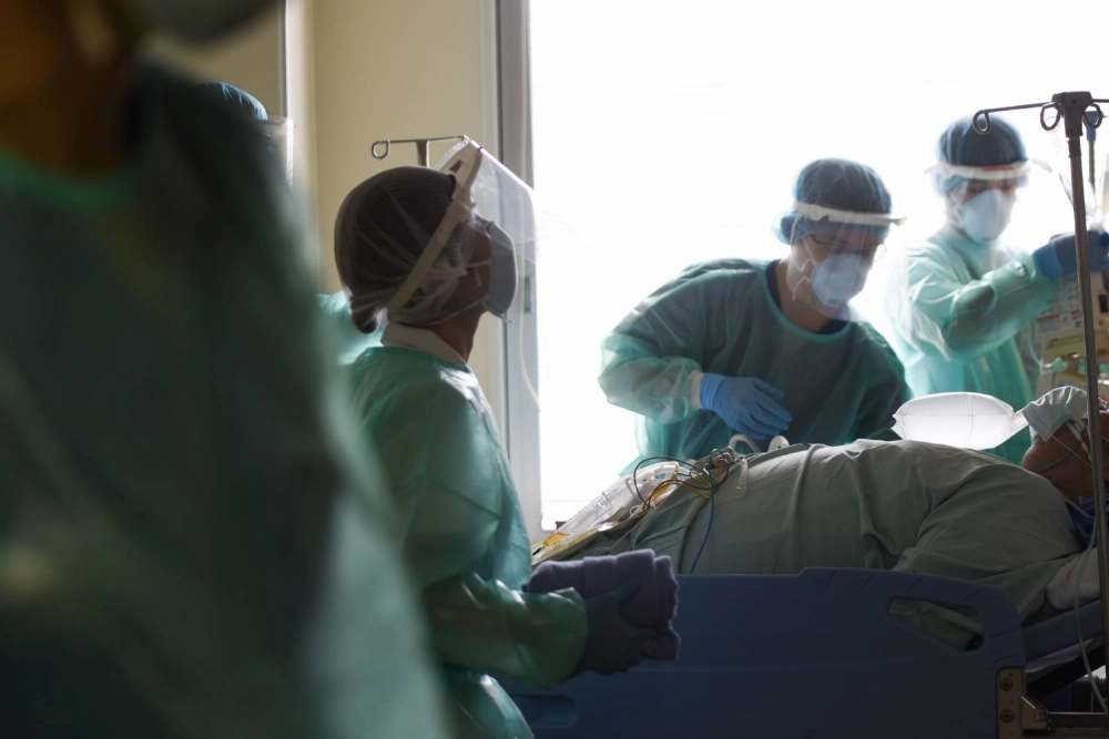Medical workers treat a patient in a COVID-19 ward at Chiba University Hospital in Chiba in August 2021. Medical workers treat a patient in a COVID-19 ward at Chiba University Hospital in Chiba in August 2021.