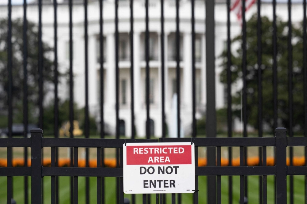A sign is attached to the exterior fence at the South Lawn of the White House as demolition work is underway on the East Wing to begin construction on U.S. President Donald Trump's planned ballroom in Washington on Saturday. A sign is attached to the exterior fence at the South Lawn of the White House as demolition work is underway on the East Wing to begin construction on U.S. President Donald Trump's planned ballroom in Washington on Saturday.