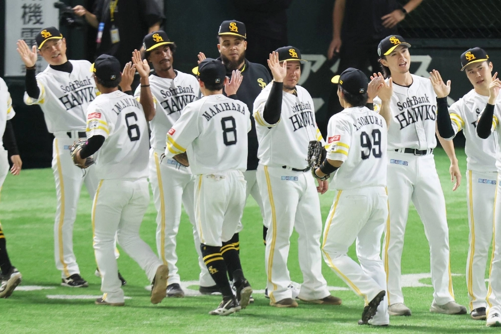 Hawks players celebrate victory over the Tigers at Mizuho PayPay Dome Fukuoka on Sunday. Hawks players celebrate victory over the Tigers at Mizuho PayPay Dome Fukuoka on Sunday.