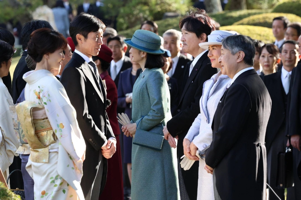 Emperor Naruhito and Empress Masako converse with jockey Yutaka Take (second from left) at the autumn garden party in Tokyo on Tuesday. Emperor Naruhito and Empress Masako converse with jockey Yutaka Take (second from left) at the autumn garden party in Tokyo on Tuesday.