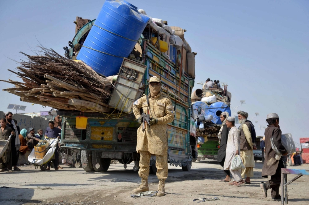 A Taliban soldier stands guard as deported Afghan refugees from Pakistan arrive at the border crossing between Afghanistan and Pakistan, in the Spin Boldak district of Kandahar province on Monday. A Taliban soldier stands guard as deported Afghan refugees from Pakistan arrive at the border crossing between Afghanistan and Pakistan, in the Spin Boldak district of Kandahar province on Monday.